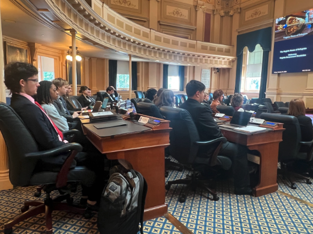 A group of students sitting in the chamber of the Virginia State Capitol